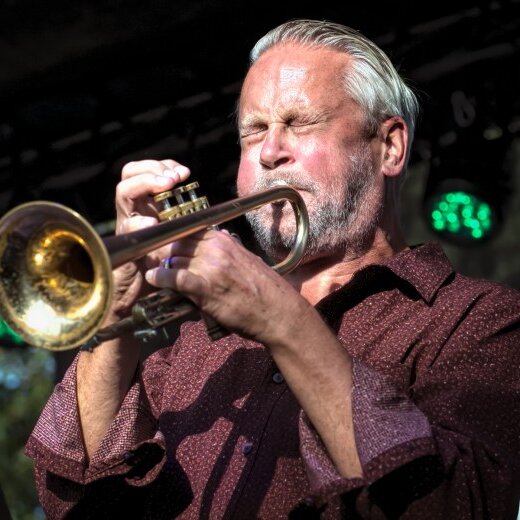 Russ Johnson playing trumpet with his eyes closed